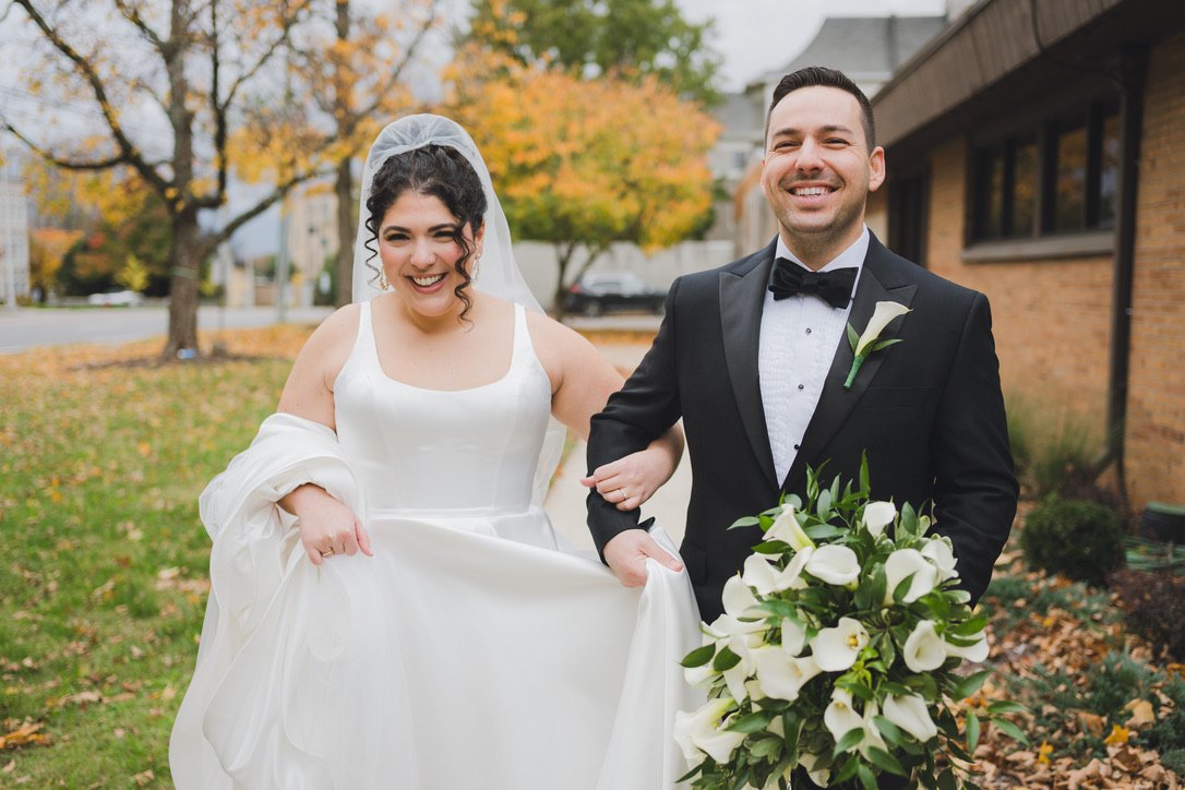 Delaney and her husband Sam laughing together on their wedding day